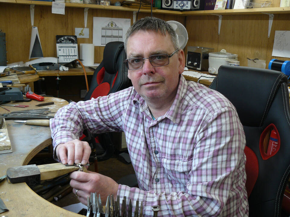 Goldsmith Richard working at his handmade garden workshop, hand-crafting Welsh gold jewellery
