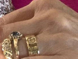 Close-up detail of a handmade Welsh gold ring showing intricate engravings of a Dragon and Mt. Fuji.