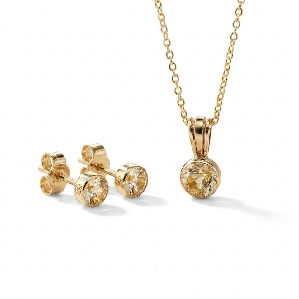 The Diamond Bezel Collection featuring the 100% Welsh gold pendant and matching stud earrings on a white background.