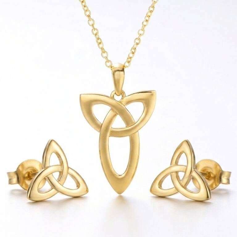 High-resolution product shot of a polished gold necklace and earring set showcasing the ancient Triquetra symbol crafted from rare Welsh gold.